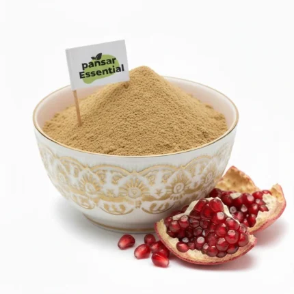 Pure Anar ka chilka powder in a bowl with fresh pomegranate pieces - Pansar Essential.